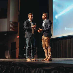 two salesmen announce a strategic sales partnership onstage