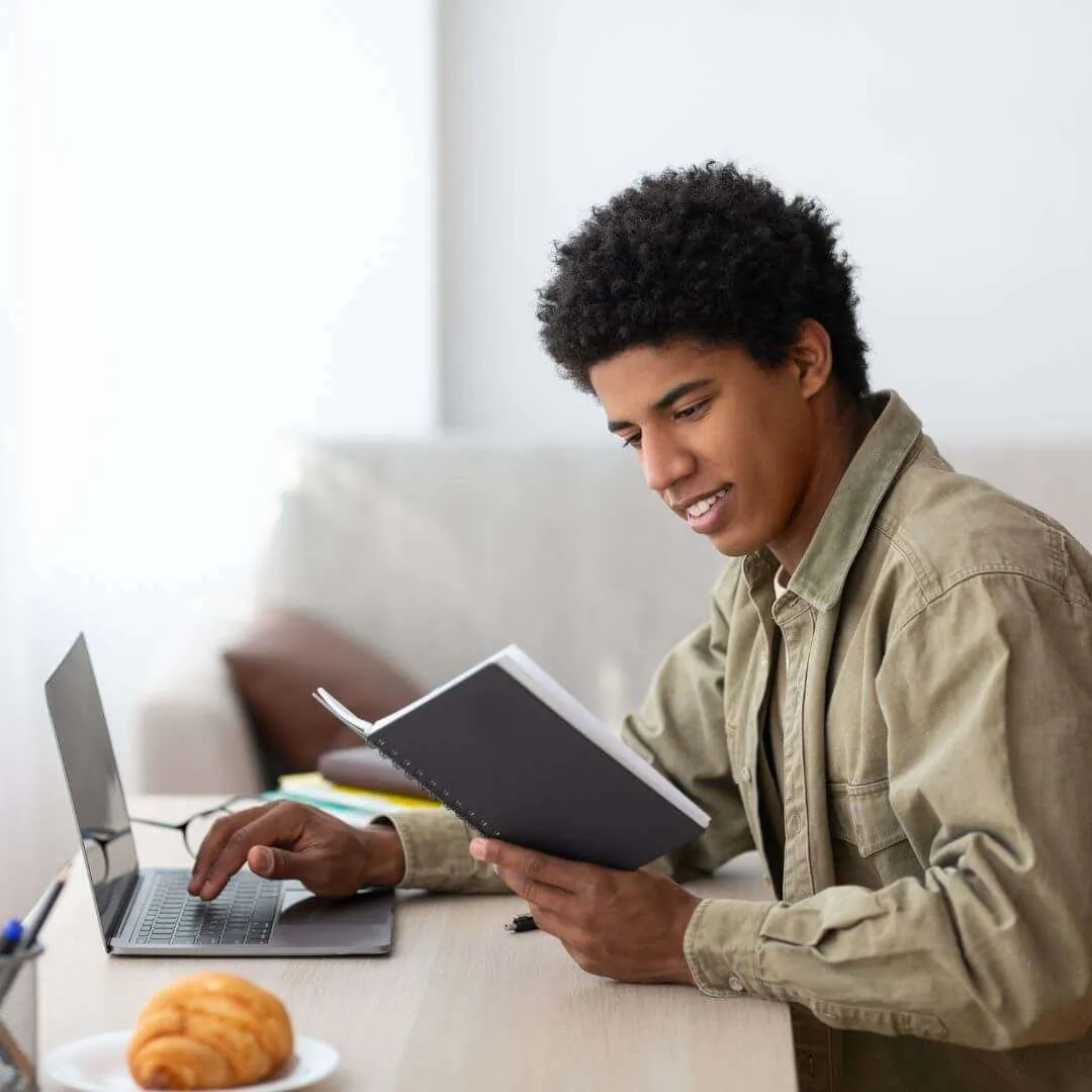 man sitting at desk working on e-learning Industry project