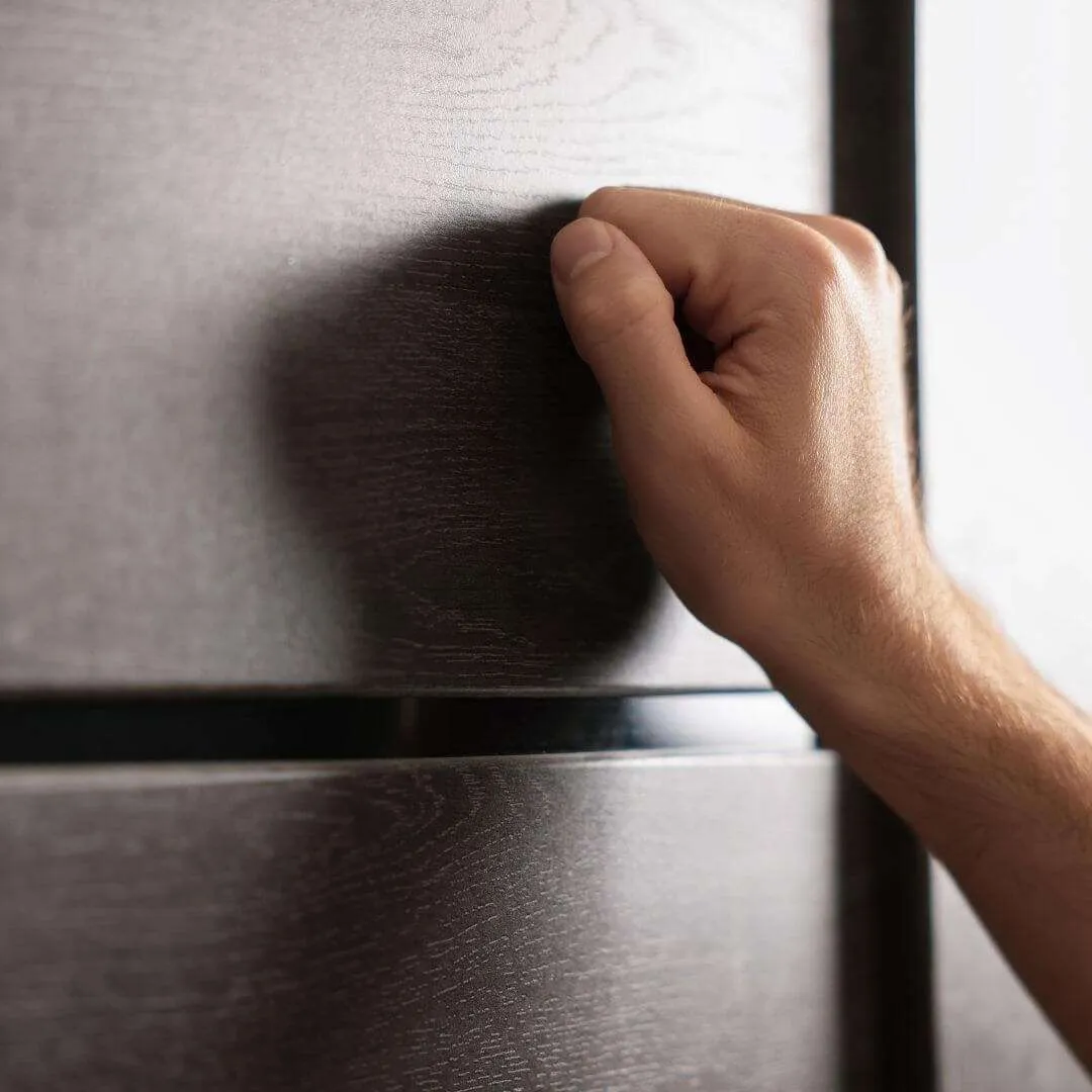 salesperson knocking on door of home